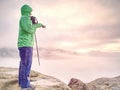 Woman looking at daybreak horizon from sharp cliff Royalty Free Stock Photo