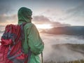 Woman looking at daybreak horizon from sharp cliff Royalty Free Stock Photo