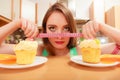 Woman with tape measure and cake. Diet dilemma. Royalty Free Stock Photo