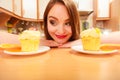 Woman looking at delicious sweet cake. Gluttony. Royalty Free Stock Photo