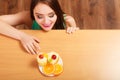 Woman looking at delicious sweet cake. Gluttony. Royalty Free Stock Photo