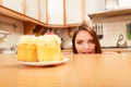 Woman looking at delicious sweet cake. Gluttony. Royalty Free Stock Photo