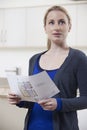 Woman Looking At Details For Property She Hopes To Buy