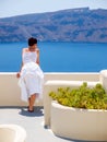 Woman looking and enjoyed on amazing sea view on Santorini island from terrace Royalty Free Stock Photo