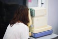 Woman looking at eye test machine in ophthalmologist. Royalty Free Stock Photo