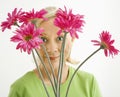 Woman looking through flowers. Royalty Free Stock Photo