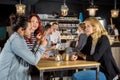 Woman Looking At Friends Conversing In Bar