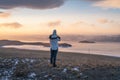 A woman looking at frozen Baikal lake at sunset, Siberia, Russia Royalty Free Stock Photo