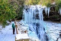 Woman Looking at a Frozen Waterfall Royalty Free Stock Photo