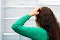 Woman looking in her empty fridge Royalty Free Stock Photo