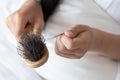 woman looking at her hair for hair loss problem