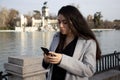 Woman looking her mobile in a park Royalty Free Stock Photo