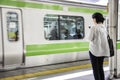 Woman looking at her phone in Yamanote line in Tokyo Royalty Free Stock Photo