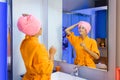 Woman looking at herself in a bathroom mirror Royalty Free Stock Photo