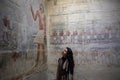 Woman looking at Hieroglyphs in Saqqara necropolis near Cairo in Egypt