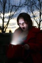 Woman looking inside her glowing bag