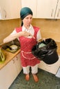 Woman Looking inside a Trash Can Royalty Free Stock Photo