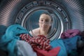 Woman looking inside the washing machine Royalty Free Stock Photo