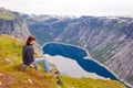 Woman looking at the lake in the mountains, Norway. Path to Trol Royalty Free Stock Photo