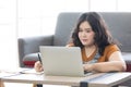 Woman looking at laptop computer and writing on notebook for work or study Royalty Free Stock Photo