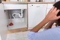 Woman Looking At Leaking Sink Pipe Royalty Free Stock Photo