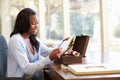 Woman Looking At Letter In Keepsake Box On Desk Royalty Free Stock Photo