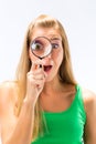 Woman looking through magnifying glass Royalty Free Stock Photo