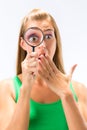 Woman looking through magnifying glass Royalty Free Stock Photo