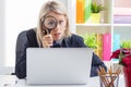 Woman looking through a magnifying glass Royalty Free Stock Photo