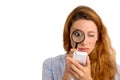 Woman looking through magnifying glass at smart phone Royalty Free Stock Photo