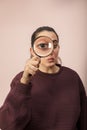 Woman looking through magnifying glass