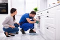 Male Plumber Cleaning Clogged Sink Pipe With Drained Cable Royalty Free Stock Photo