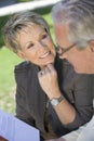 Woman Looking At Man Reading Novel