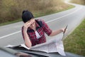 Woman looking at map on car Royalty Free Stock Photo