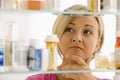 Woman Looking in Medicine Cabinet Royalty Free Stock Photo