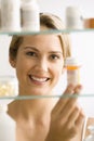 Woman Looking in Medicine Cabinet Royalty Free Stock Photo