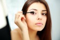 Woman looking at mirror while doing makeup Royalty Free Stock Photo