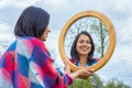 Woman looking at mirror outside in nature Royalty Free Stock Photo