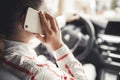 Woman looking at mobile phone while driving a car. Driver using smart phone in car. Royalty Free Stock Photo