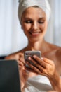 Woman looking on mobile screen and gesturing for expressing happiness. Good news, emotions and technology concept. Woman