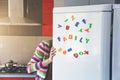 Woman looking in open fridge with Family letters Royalty Free Stock Photo