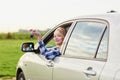 Woman looking out of the car window and holding a key Royalty Free Stock Photo