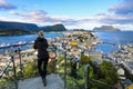 Woman looking out at colorful town of Alesund Norway Royalty Free Stock Photo