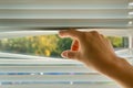 Woman is looking out through jalousie