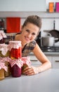 Woman looking out from jars in kitchen Royalty Free Stock Photo