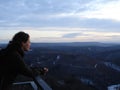 Woman looking out of the lookout to the landscape at dusk Royalty Free Stock Photo