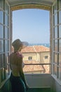 Woman looking out of the Picasso Museum, Antibes, France Royalty Free Stock Photo