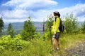 Woman looking out to vast wilderness while hiking