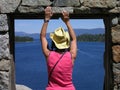 Woman looking out window at Tea House on Fannette Island