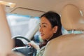 Woman looking over her shoulder while driving a car. Royalty Free Stock Photo